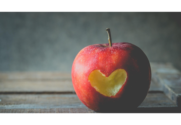 Red Apple with a heart shaped bite out the side of it.