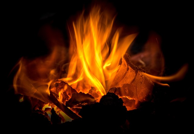 Dancing flames of a fire at night time.