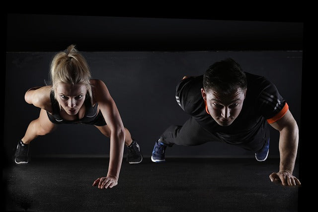 Man and lady doing press-ups.