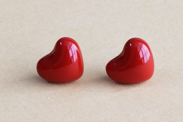 Two red pills in the shape of hearts alongside each other.